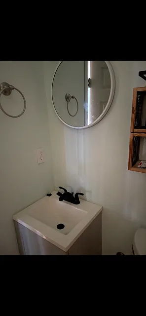 Bath faucet and cabinet and mirror.