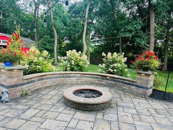 Outside: Enjoy a large, well-maintained backyard featuring a renovated patio, a charming screened-in porch with cafe lights, and a convenient outdoor shed for additional storage.