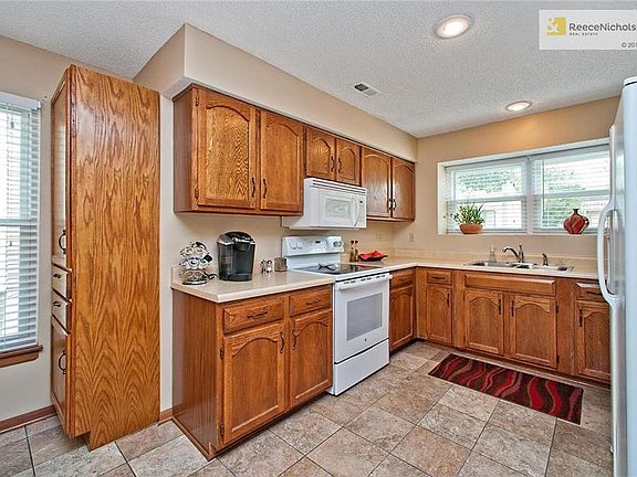 Master w/Pantry, Tile Floor, Newer Glass Cooktop, Microwave, Newer Dishwasher, Window Ledge, Frig Stays and Open to Family Room