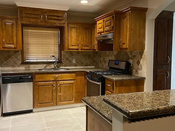 Another view of the kitchen and the gas cooktop.
