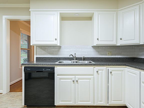 Kitchen with view of dining room access; dishwasher