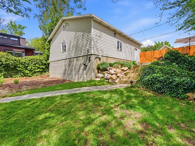 Huge 4 car garage with work bench accessible from the back alley. Additional walkway to the home from here.