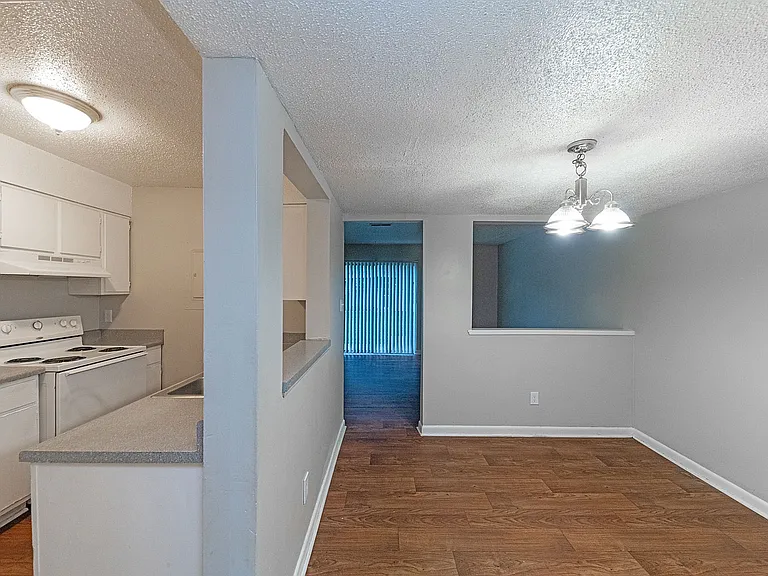 Dining area with hardwood-style flooring & overhead lighting