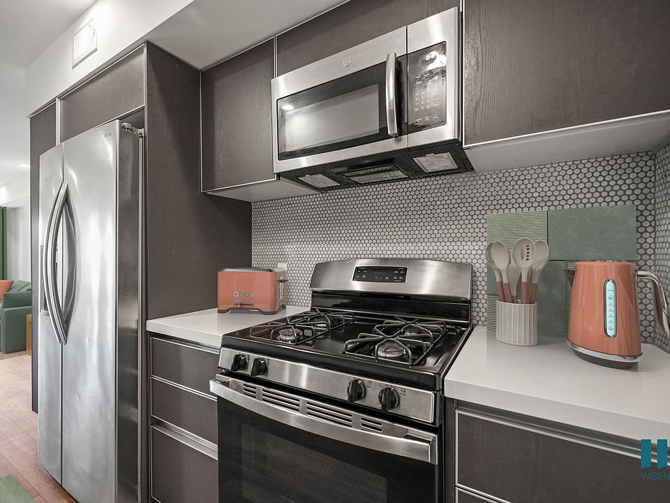 Kitchen with Stainless-Steel Refrigerator, Stove, and Microwave Oven