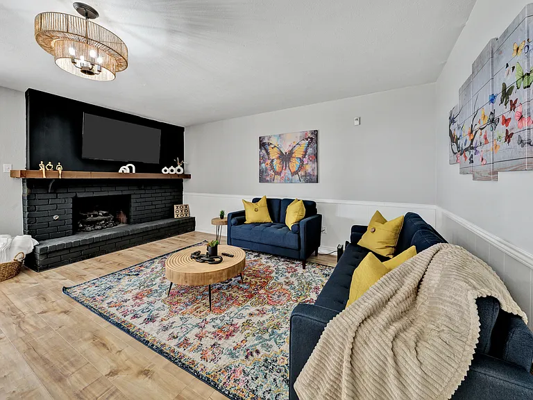 second living area open to the kitchen and dining area, with gas fireplace