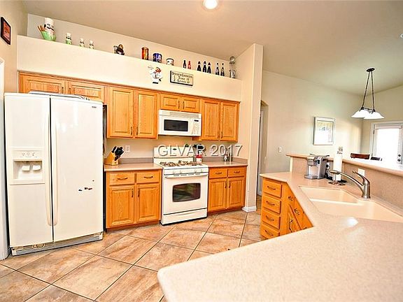 Open Kitchen with breakfast bar and walk in pantry.  Tile floor with corian countertops.  Breakfast nook area. Refrigerator Incl