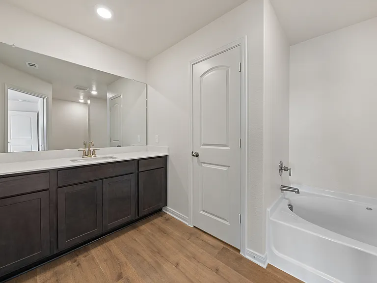 The master bathroom has a large vanity space.