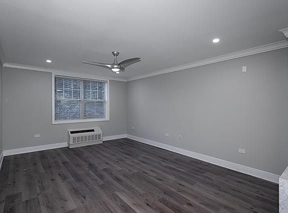 Living Room with Plank Vinyl, Hi-Hat Lights, Wave Ceiling Fan, Gray Paint, Crown/Base Molding, Window Treatments, AC