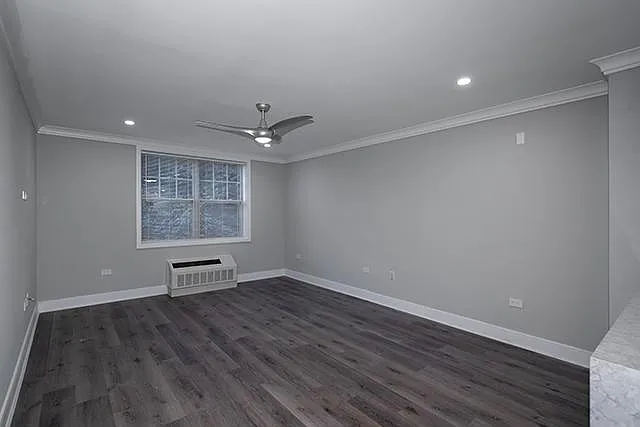 Living Room with Plank Vinyl, Hi-Hat Lights, Wave Ceiling Fan, Gray Paint, Crown/Base Molding, Window Treatments, AC