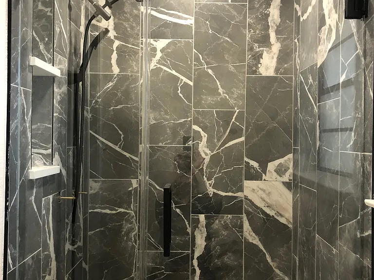 Main shower with glass door, had held and rain shower heads