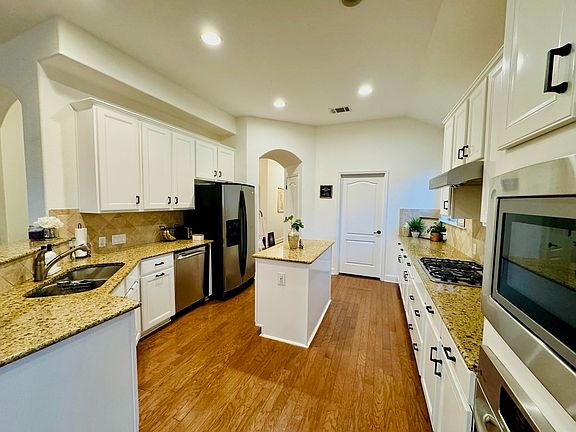 Renovated kitchen, with brand-new built-in gas range, microwave, and sink fixture