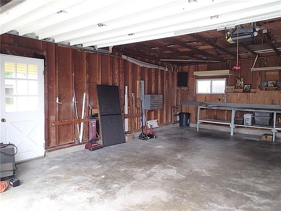 Interior of garage space with large workbench and some storage cabinets!