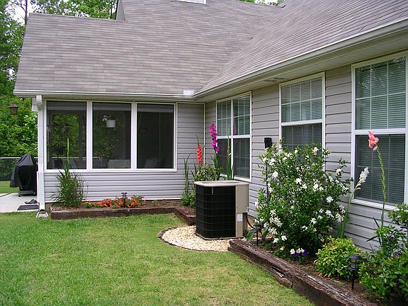 View of screened in porch in backyard