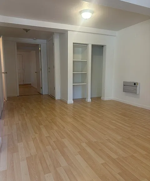 entry looking down hall towards bedroom. built in cozy cabinet
