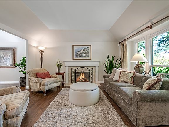 The formal living room sets the tone with its coffered ceiling, updated window package, updated hardwood floors and wood-burning fireplace. Notice the chic, mantel that is surrounded by marble, adding that final touch of perfection.