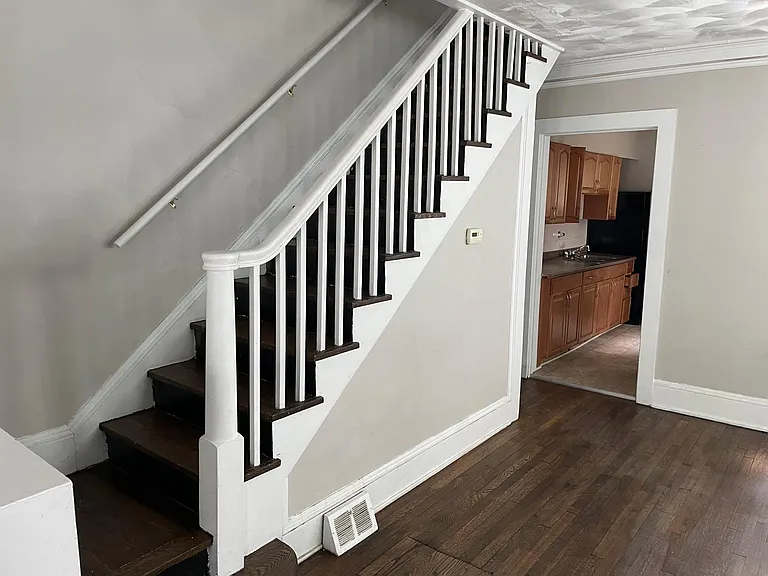 1st floor looking up stairs and into the Kitchen