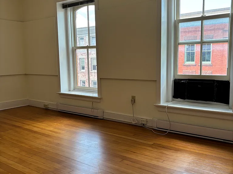 Front bedroom, hardwood floors, walk-in closet.