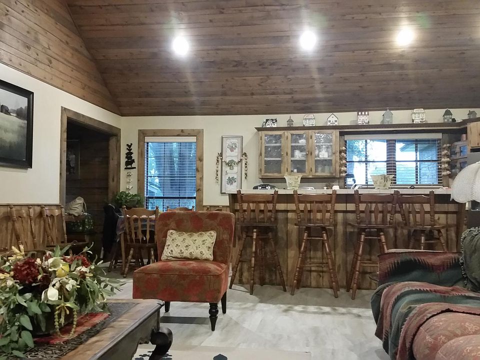 open living area with tall ceilings trimmed with cedarwood.