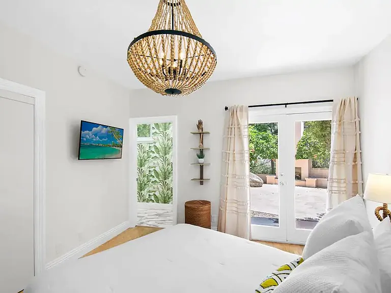 Guest bedroom with en-suite bathroom and patio access.