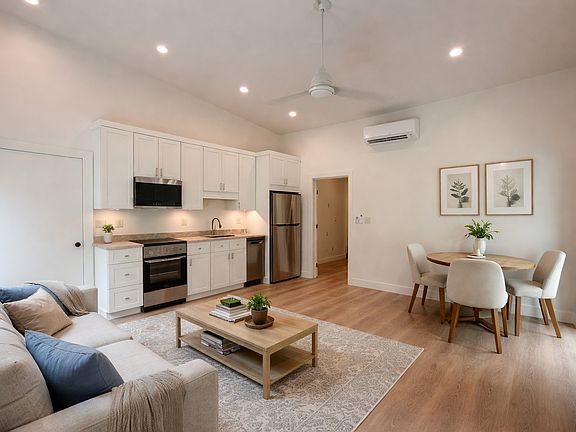 Light filled living/dining area virtually staged to show possible furniture placement.
