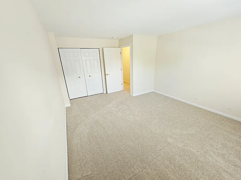 2nd Bedroom looking toward door and closets.