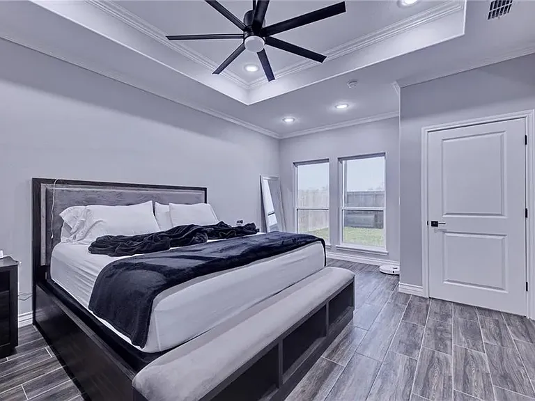 Spacious primary bedroom with plenty of natural light.