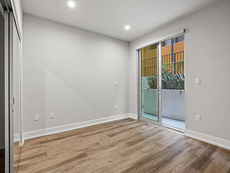 Bedroom with Mirrored Closet, Vinyl Flooring, and Balcony with Private Entrance