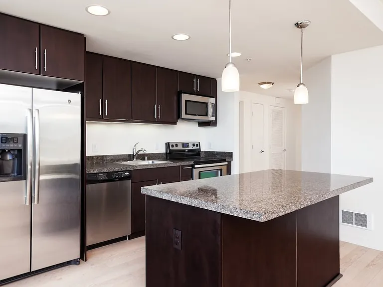 Classic Phase III kitchen with granite countertops, espresso cabinetry, and hard surface flooring