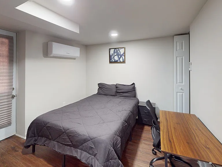 Workspace with adjustable office chair and closet for easy storage.