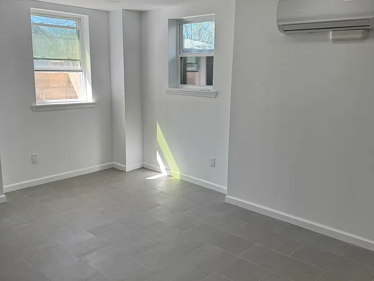 Open Floor Plan Living Room connected to Kitchen with Independent Energy Efficient HVAC unit head....Aple Natural Light