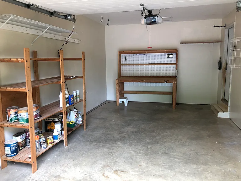 Garage. Lighted work bench and shelves stay with the house.