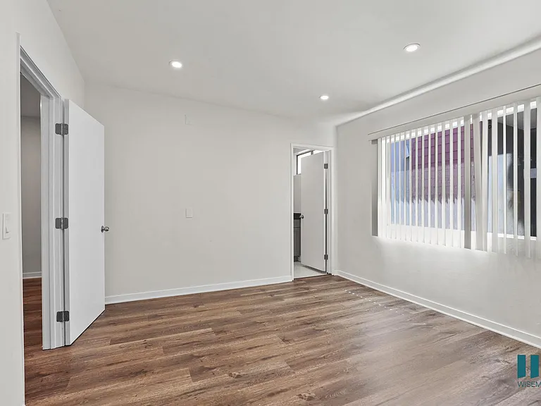 Spacious Bedroom with Large Windows, Bathroom, and Vinyl Flooring