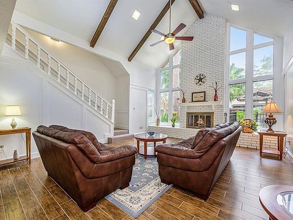 Living is easy and comfortable is this beautiful family/living room with soaring windows overlooking the beautiful backyard.
