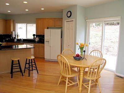 Spacious kitchen w gleaming hardwood floor, nook overlooking serene nature