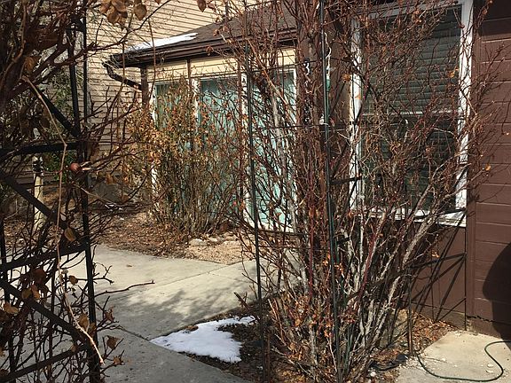 Front Entry with rosebush-framed metal arbor.