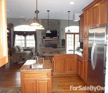 Kitchen with Open floor plan
						:
						Center island has an additional sink. Granite countertops
