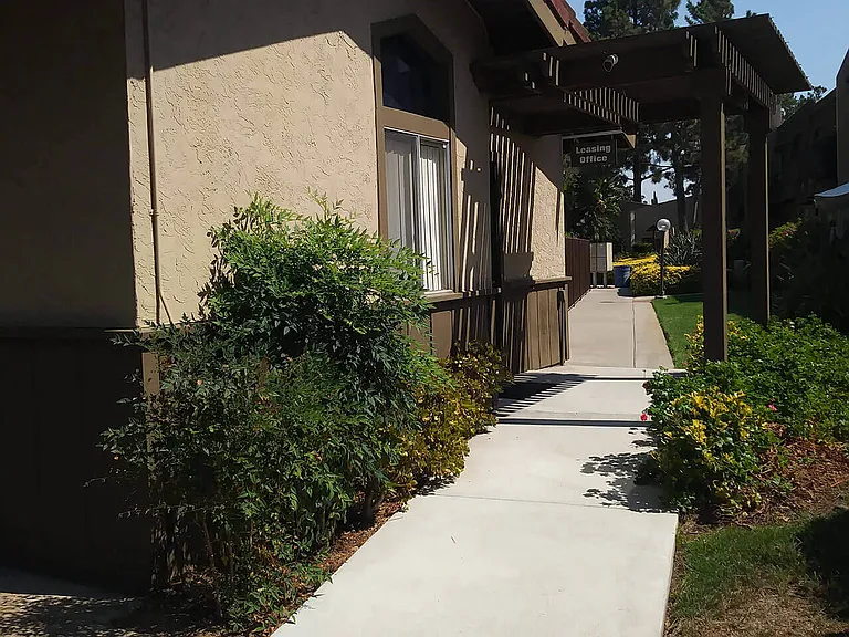 Walkway to leasing office at Teton Pines Apartments in Escondido, California.