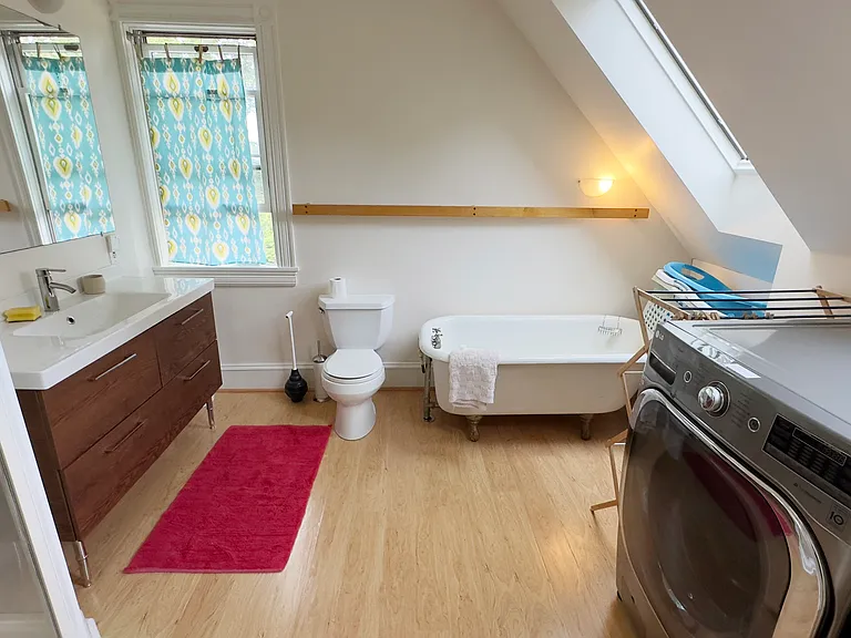 3rd floor bathroom with shower, bathtub, washer and dryer