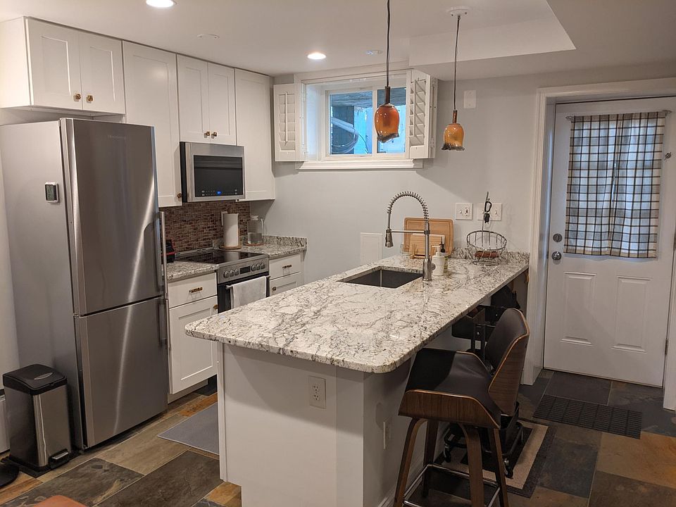 Premium stainless steel appliances, including a dishwasher (in island)