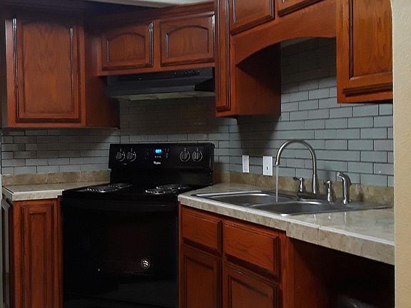 New paint, stove, water faucet, and floor tile.