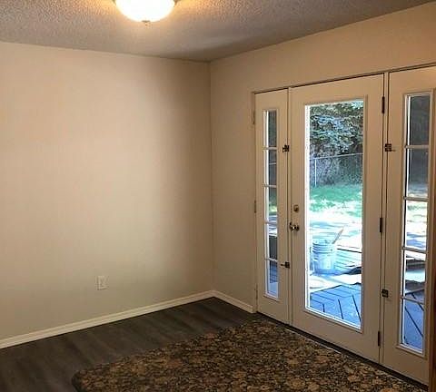 Eating area in kitchen that leads out back to deck and yard.