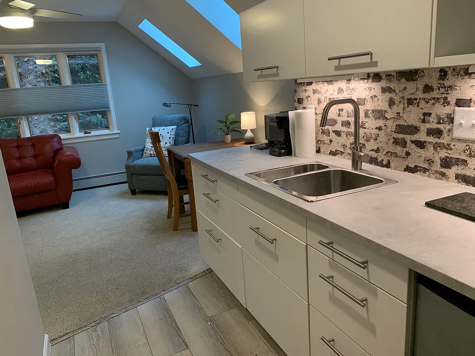 Skylights and table/desk in living area off kitchen.