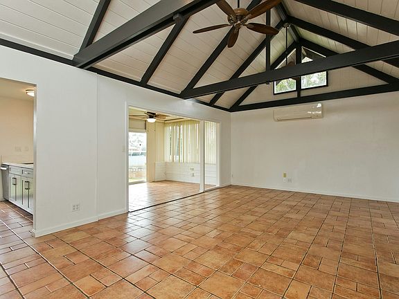 Spacious main living area with Split AC open to kitchen, dining and outdoors.