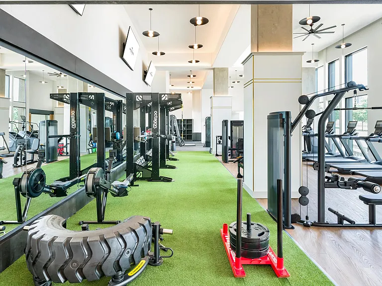 Expansive two-story fitness studio with cardio, strength, and functional training zones.
