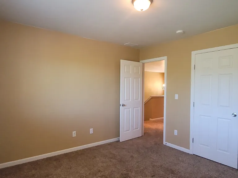 Second bedroom looking back to the stairs.