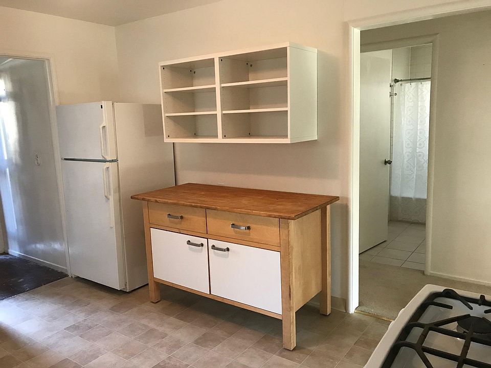 Kitchen, with view to hallway/bathroom (hallway flooring has