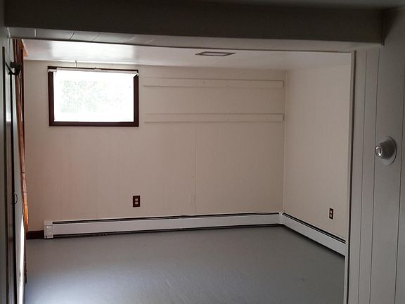 Front half of the main room with large window.