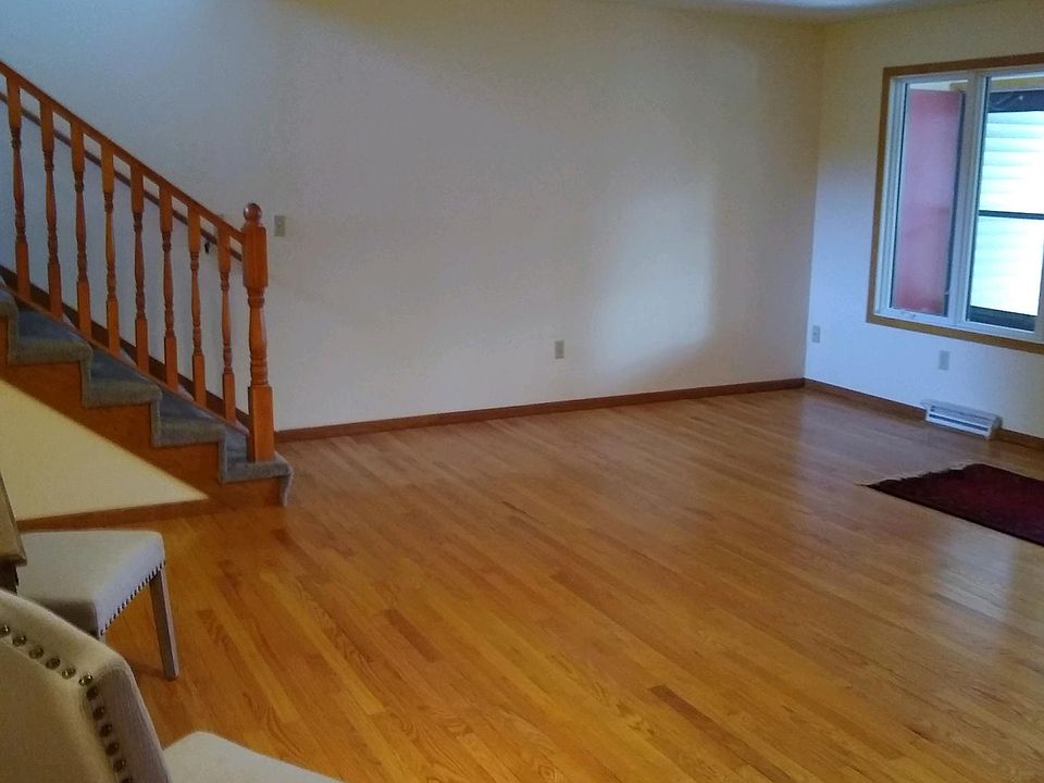 Warm oak hardwood floors in spacious living room.