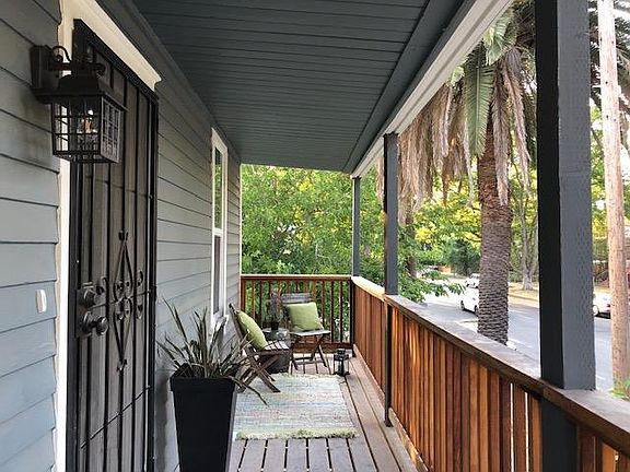 View of the 125 sf covered front porch overlooking tree-lined 2nd Avenue. Porch is 5 feet wide x 25 feet long.