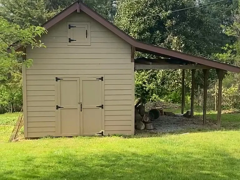Work shed with concrete floors, electric, covered area, etc.